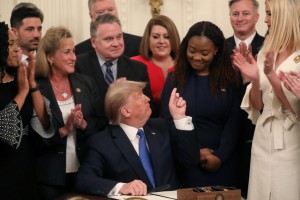 U.S. President Donald Trump points to human trafficking survivor Bella Hounakey after signing an Executive Order on "Combating Human Trafficking and Online Child Exploitation in the United States" at the White House Summit on Human Trafficking in the East Room of the White House in Washington, U.S., January 31, 2020. REUTERS/Leah Millis